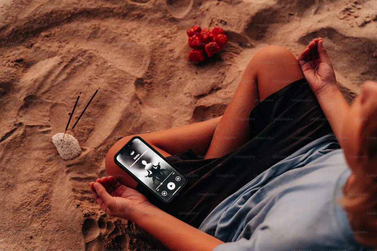 Person meditating with a phone nearby in a calm setting