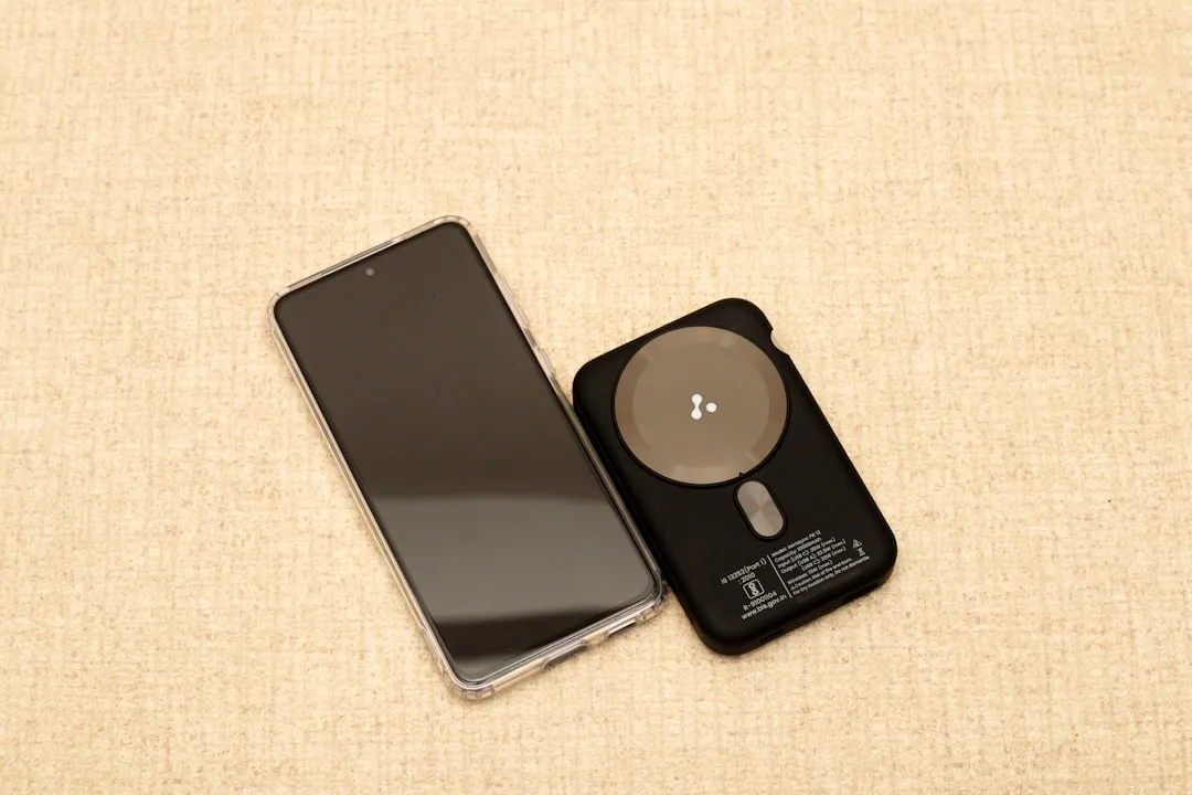 Smartphone and wireless charger on a textured surface | Photo by VD Photography on Unsplash