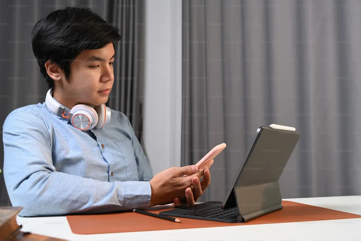 Student using assistive technology on a tablet with headphones